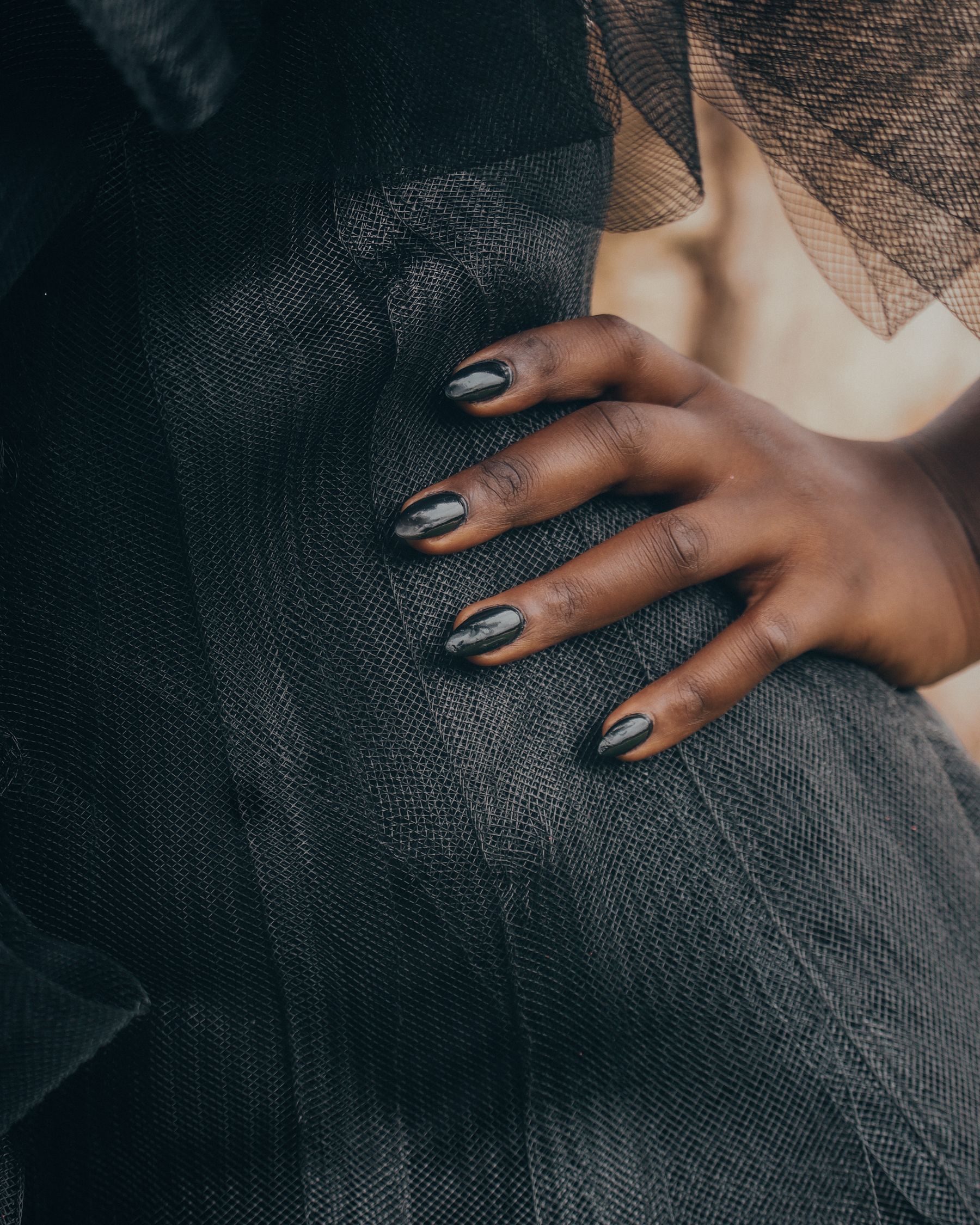 Hand on textured black fashion fabric