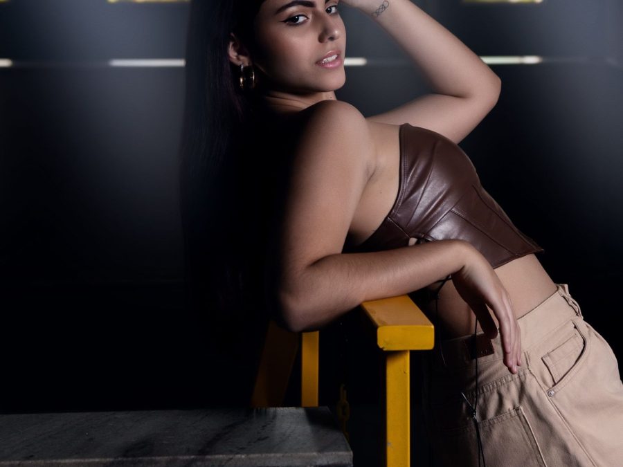 Fashion model seated in a neutral-toned look