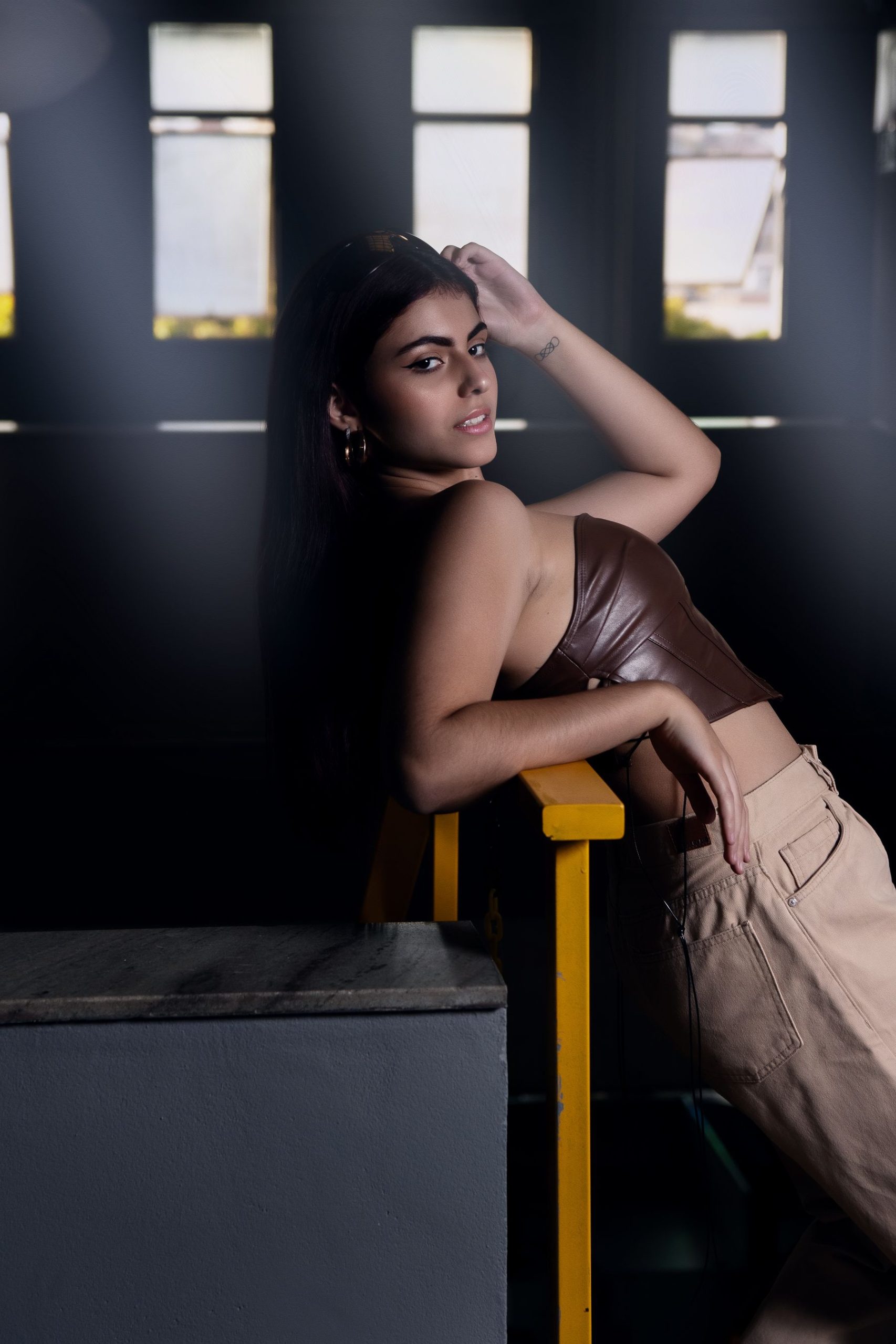 Fashion model seated in a neutral-toned look