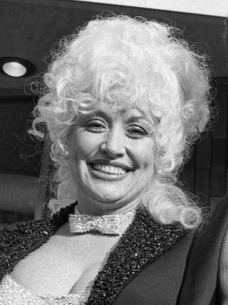 Dolly Parton in a sparkling black look and rhinestone choker in 1984